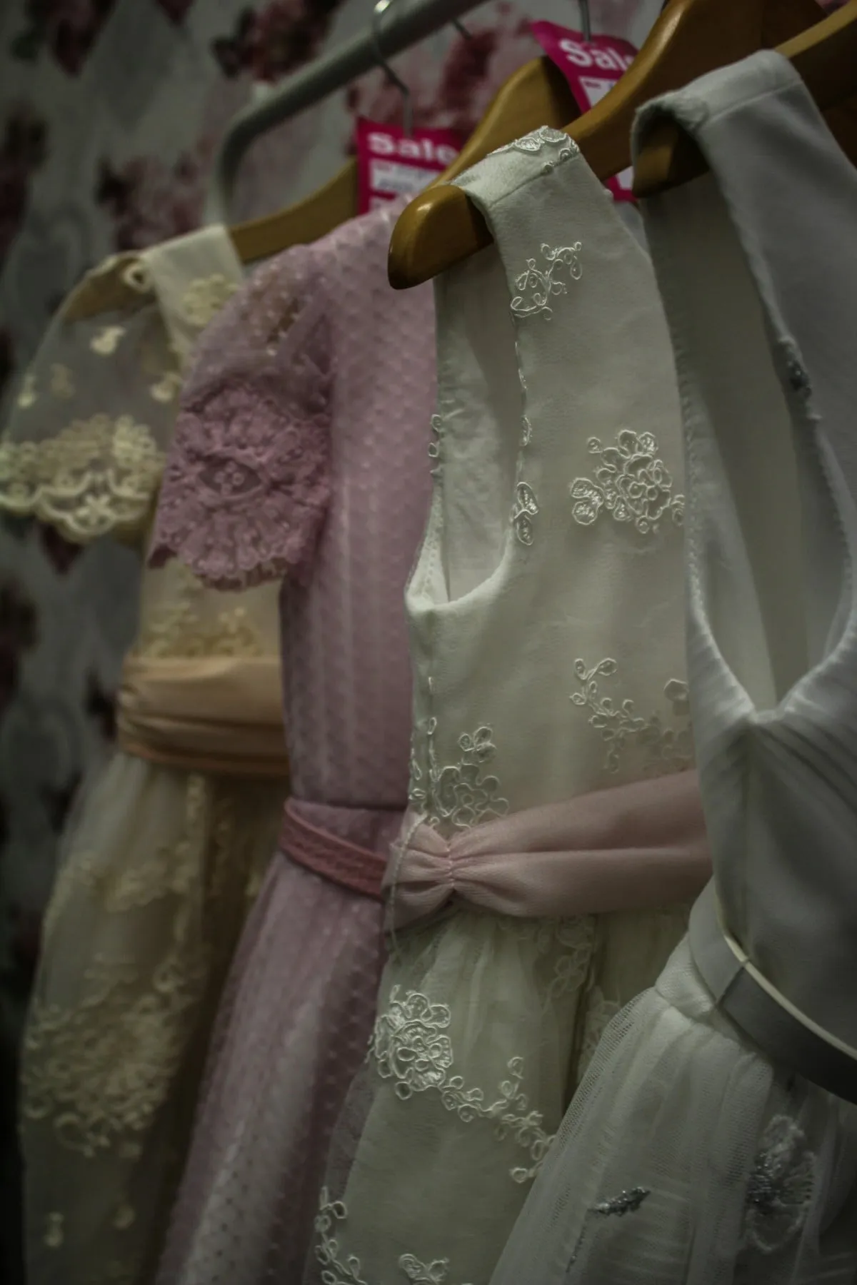 Occasion dresses hanging on a boutique rail