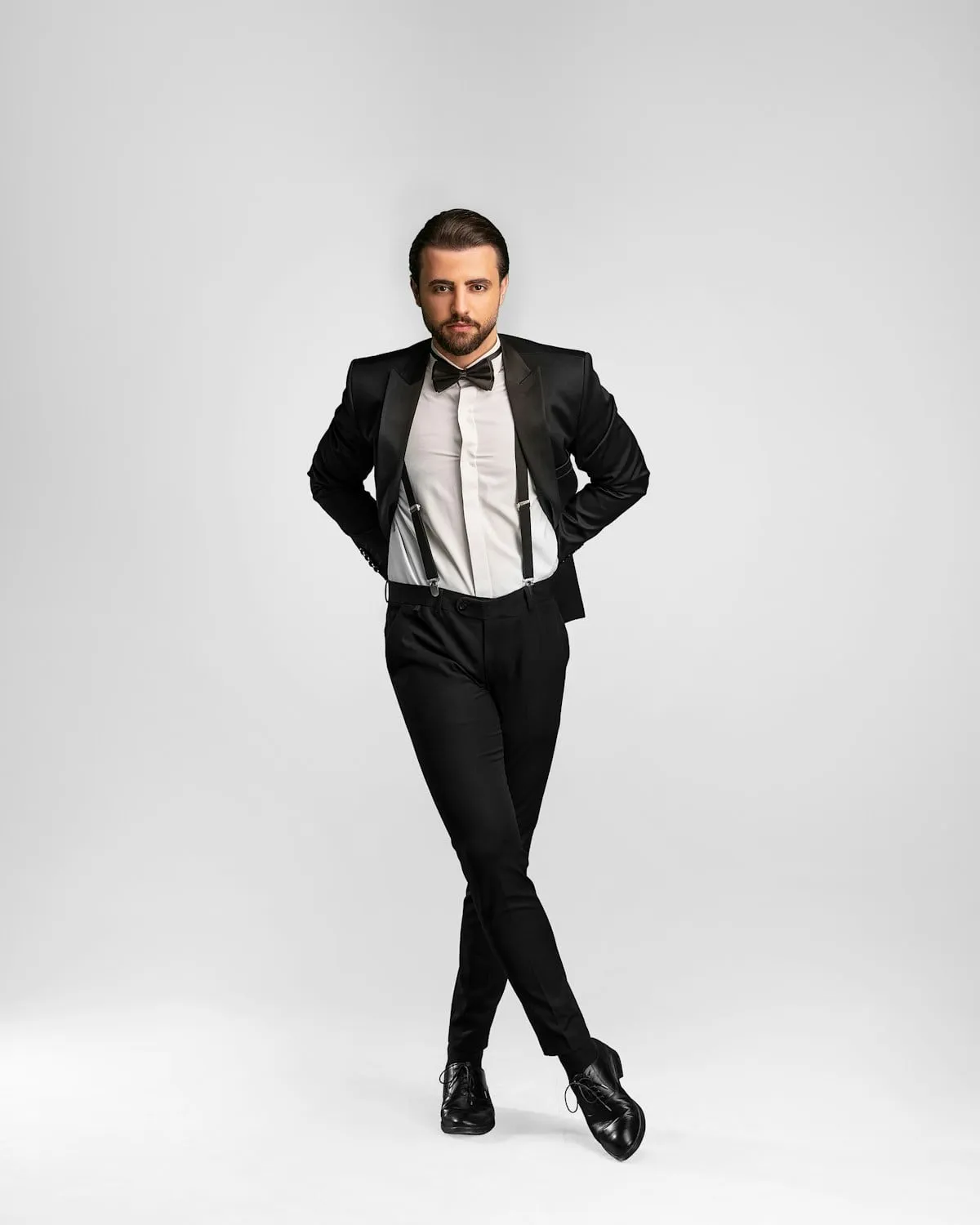Man wearing a black tuxedo with a bow tie
