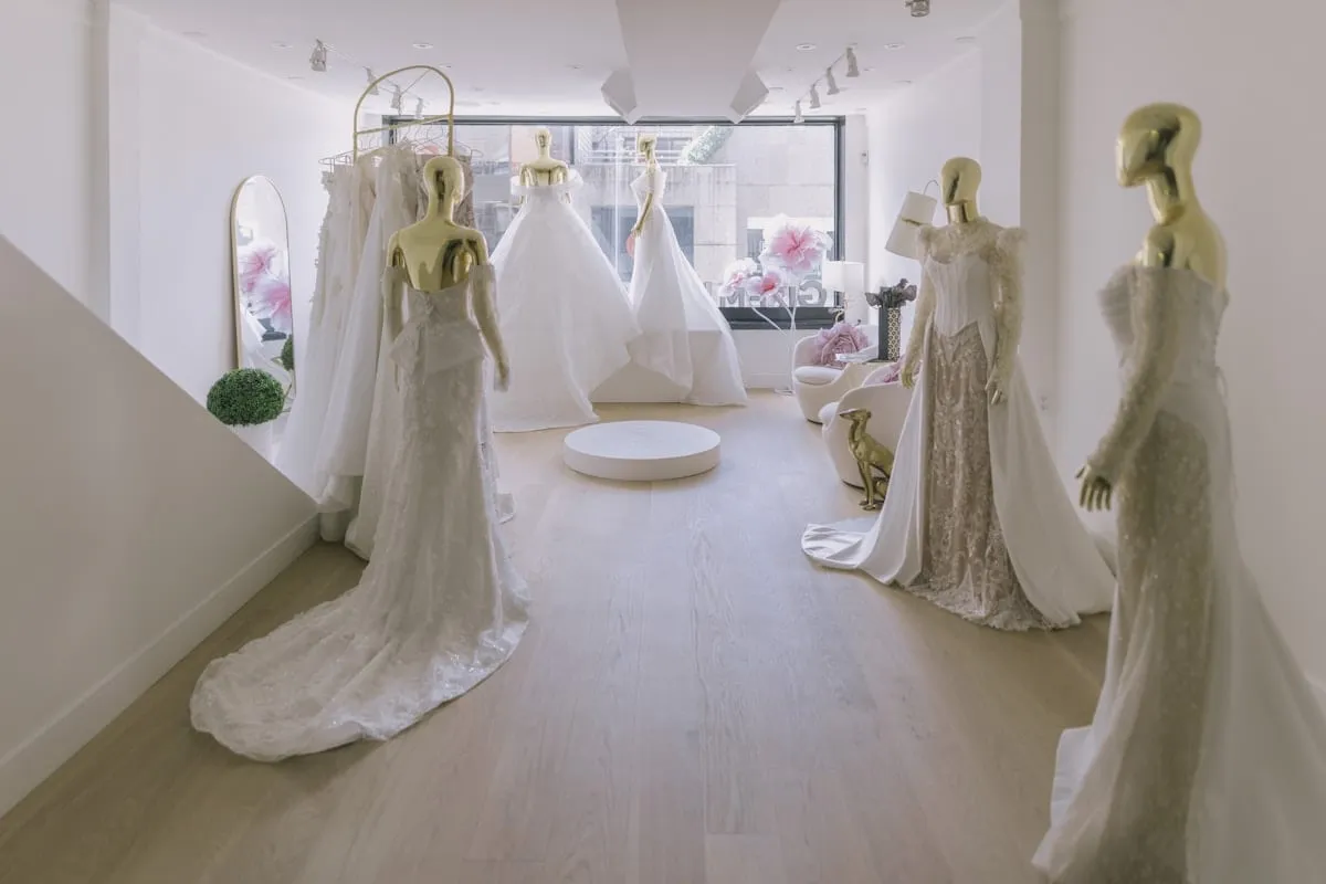 White wedding gowns displayed in a bridal boutique